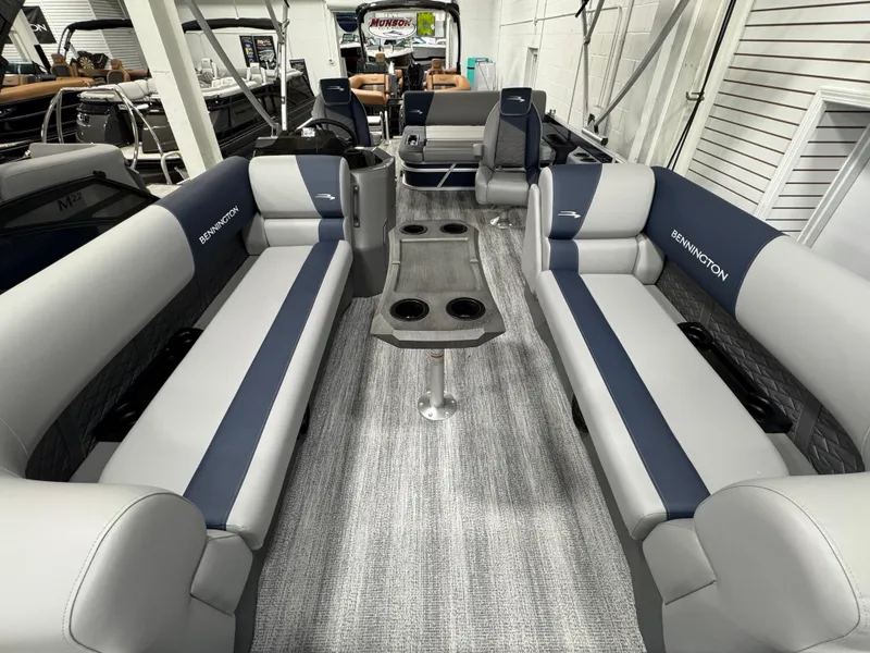Slide: The Image of 2025 Bennington 22 SSB pontoon boat interior with gray and blue seating and central table. - 9