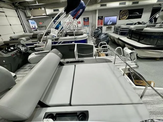 Slide: The Image of 2025 Bennington 22 SSB pontoon boat interior with gray seating in showroom. - 18