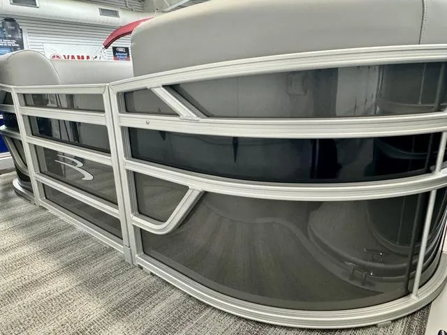 Slide: The Image of 2025 Bennington 22 SSB pontoon boat with sleek black and silver design. - 2