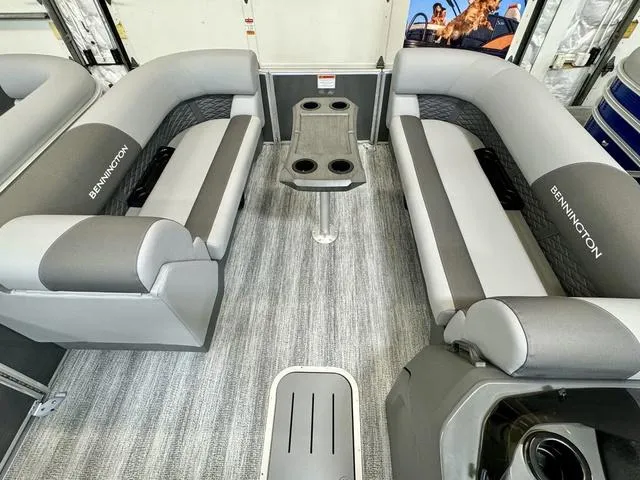 Slide: The Image of 2025 Bennington 22 SSB pontoon boat interior with gray seating and central table. - 3
