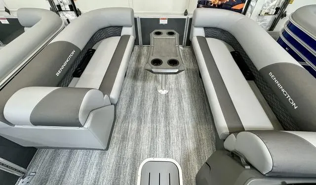 Slide: The Image of Interior of 2025 Bennington 22 SSB pontoon boat with gray seating and central table. - 6