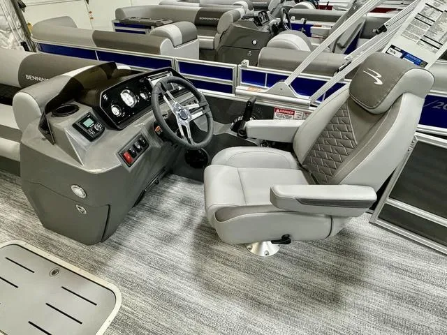 Slide: The Image of 2025 Bennington 22 SSB boat interior with steering console and captain's chair. - 7