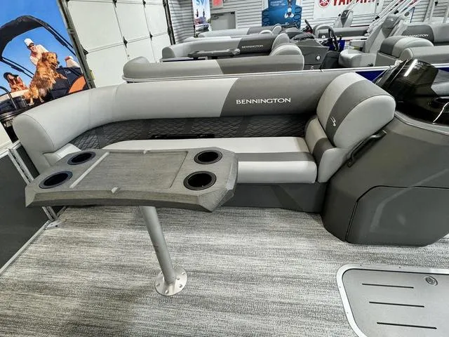 Slide: The Image of 2025 Bennington 22 SSB boat interior with gray seating and table. - 8