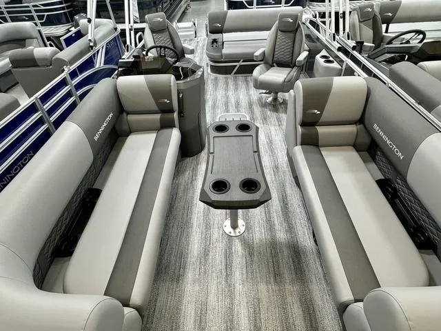 Slide: The Image of 2025 Bennington 22 SSB pontoon boat interior with gray seating and central table. - 9
