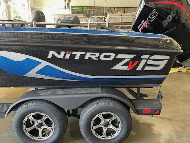 Slide: The Image of 2025 Nitro ZV19 boat on trailer in garage setting. - 0