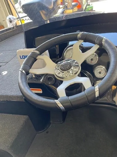 Slide: The Image of 2025 Nitro ZV19 boat dashboard with steering wheel and gauges. - 6