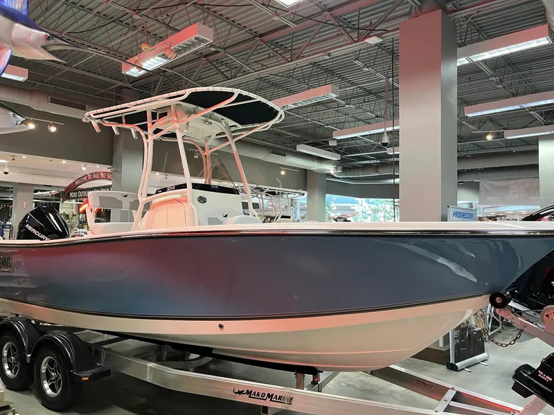 The Image of 2025 Mako 214 CC boat displayed indoors on a trailer. - 0