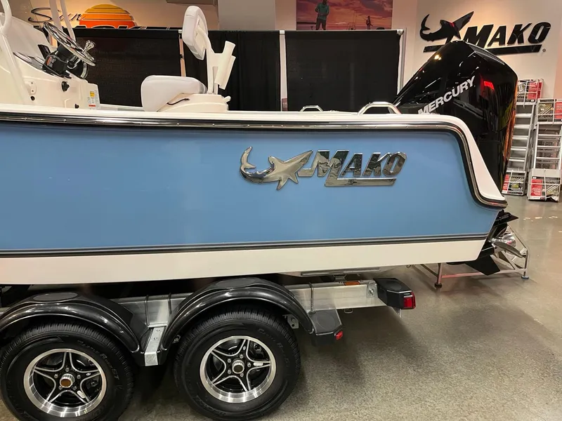 Slide: The Image of 2025 Mako 214 CC boat on trailer, blue hull, showroom display. - 3
