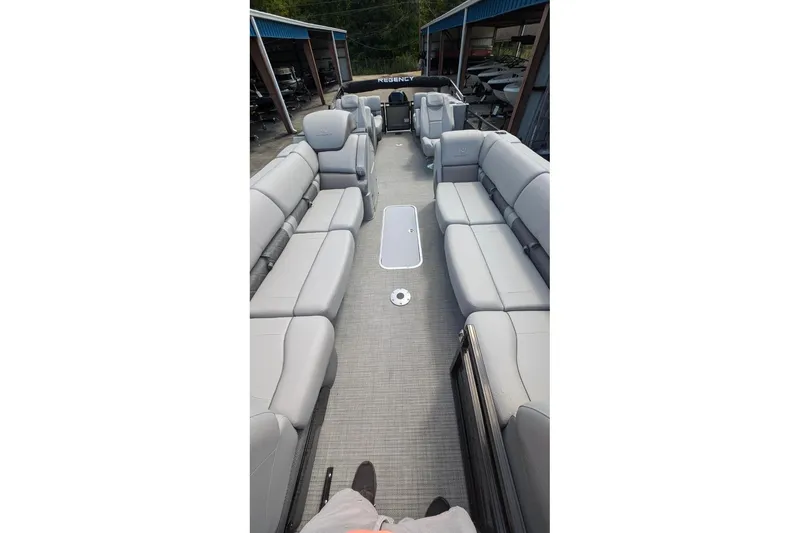 Slide: The Image of 2025 Regency 250 LE3 pontoon boat with spacious gray seating and modern design. - 2