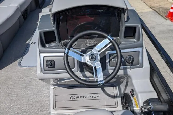 Slide: The Image of 2025 Regency 250 LE3 boat dashboard with steering wheel and control panel. - 3