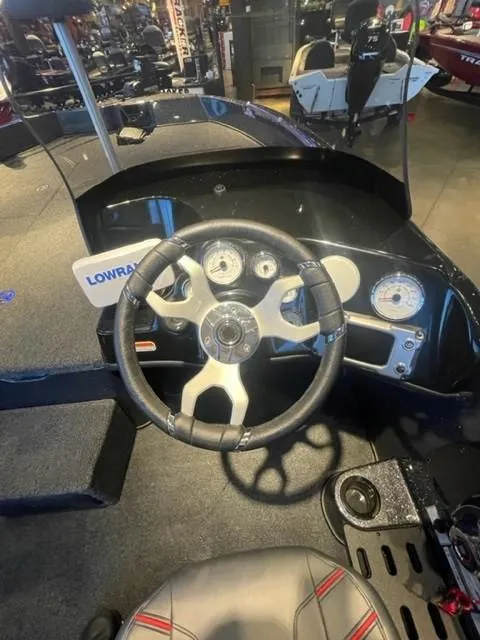 Slide: The Image of 2025 Nitro ZV19 boat dashboard with steering wheel and gauges. - 6