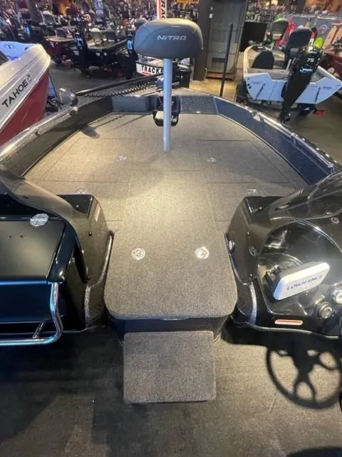 Slide: The Image of 2025 Nitro ZV19 boat interior with seating and steering wheel in showroom. - 7