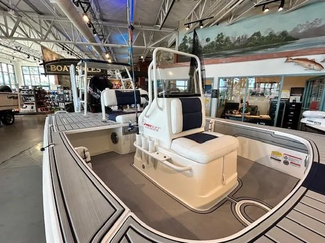 Slide: The Image of 2025 Mako 18 Pro Skiff Patriot Edition boat displayed in showroom. - 1