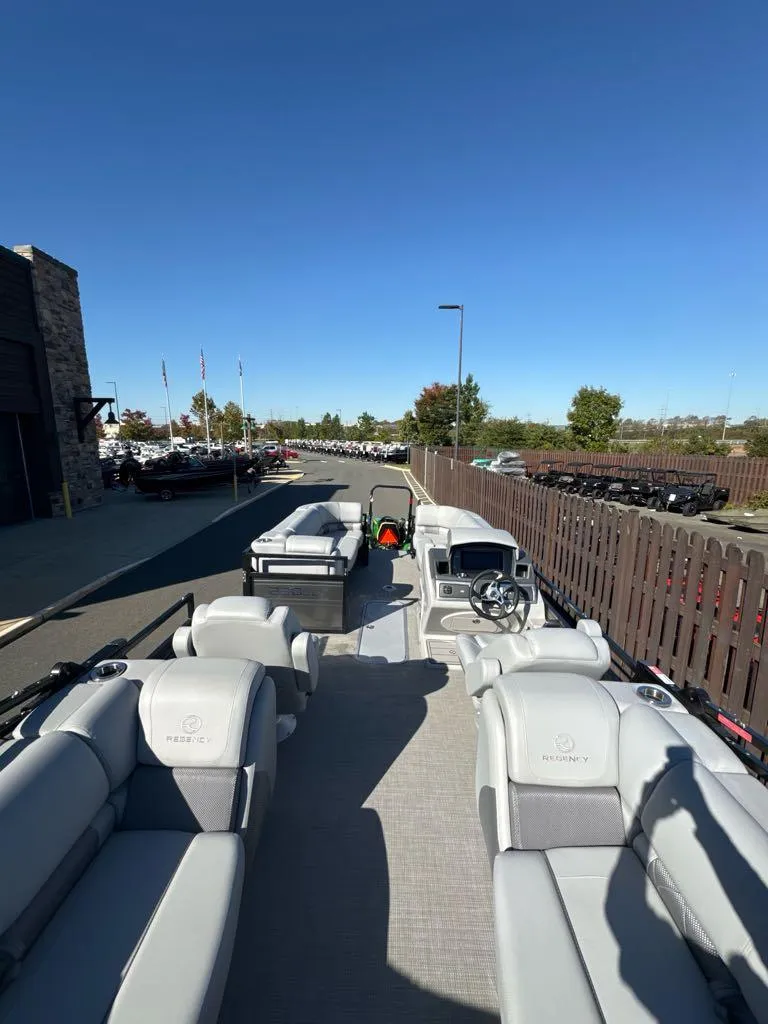 Slide: The Image of 2025 Regency 230 LE3 pontoon boat with spacious seating and modern design. - 2