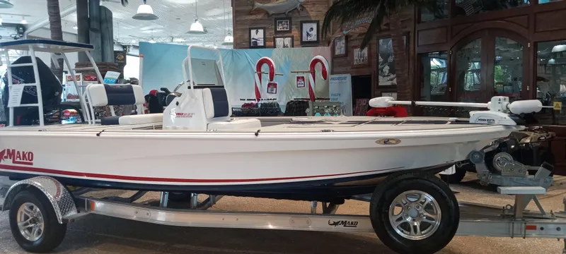 Slide: The Image of 2025 Mako 18 Pro Skiff Patriot Edition on display in showroom. - 2
