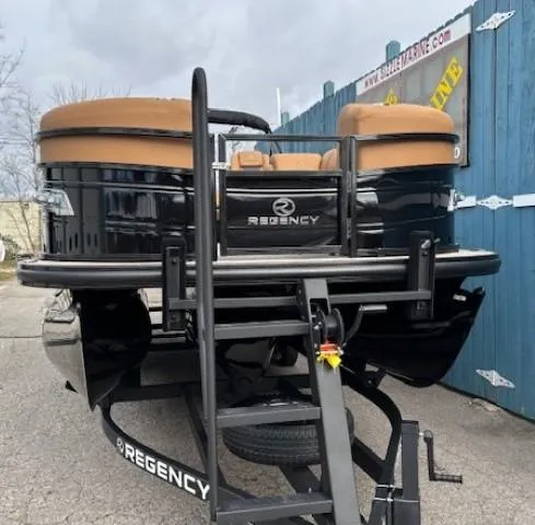 Slide: The Image of 2025 Regency 230 LE3 pontoon boat on trailer, black with tan seats. - 2