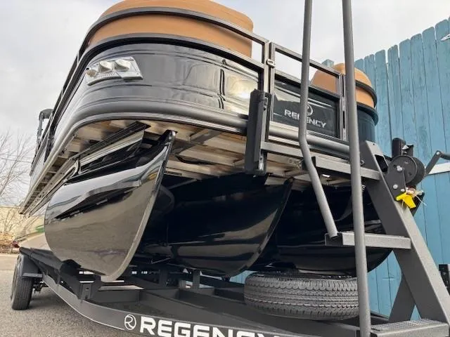 Slide: The Image of 2025 Regency 230 LE3 pontoon boat on trailer, sleek black design. - 3