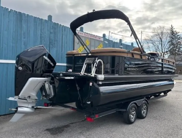 Slide: The Image of 2025 Regency 230 LE3 pontoon boat on trailer, featuring sleek black design and powerful Mercury outboard. - 4