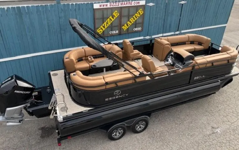 Slide: The Image of 2025 Regency 230 LE3 pontoon boat on trailer at Sizzle Marine dealership. - 6