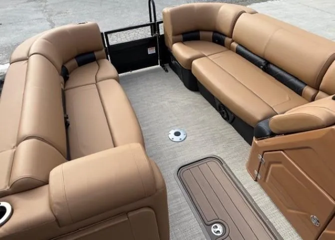 Slide: The Image of 2025 Regency 230 LE3 boat interior with tan seating and spacious layout. - 7