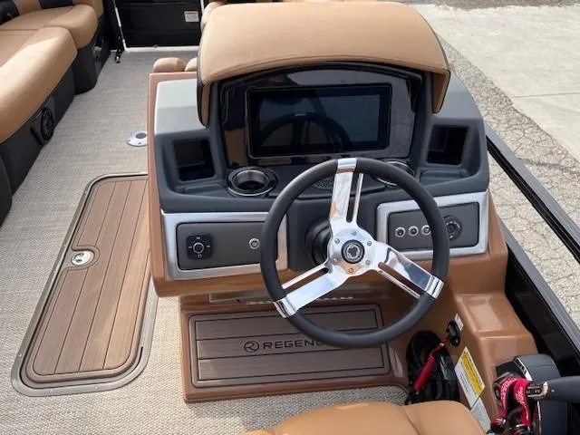 Slide: The Image of 2025 Regency 230 LE3 boat dashboard with steering wheel and control panel. - 9