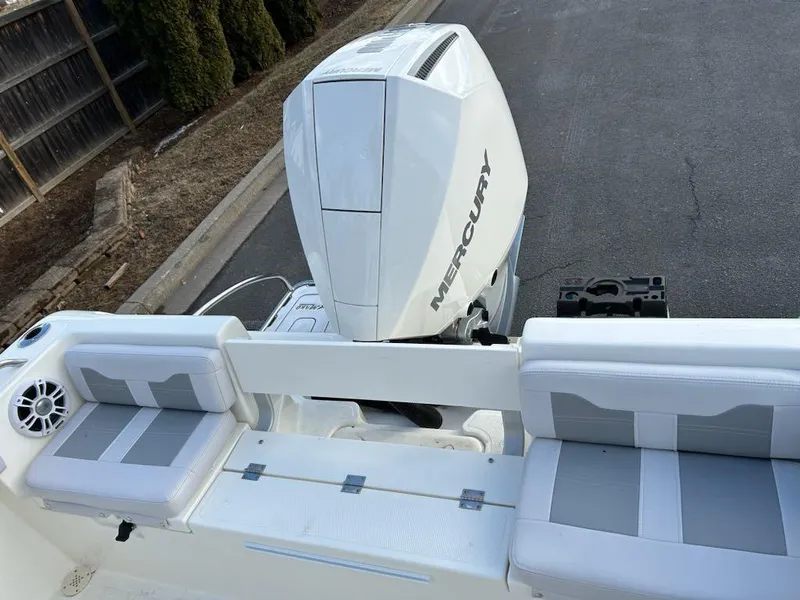 Slide: The Image of 2025 Mako 214 CC boat with Mercury engine, featuring cushioned seating. - 4