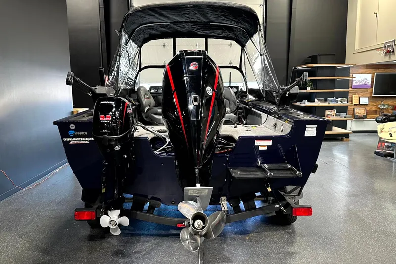 Slide: The Image of 2025 Tracker Targa V-19 WT boat with dual Mercury outboard motors in a showroom. - 12