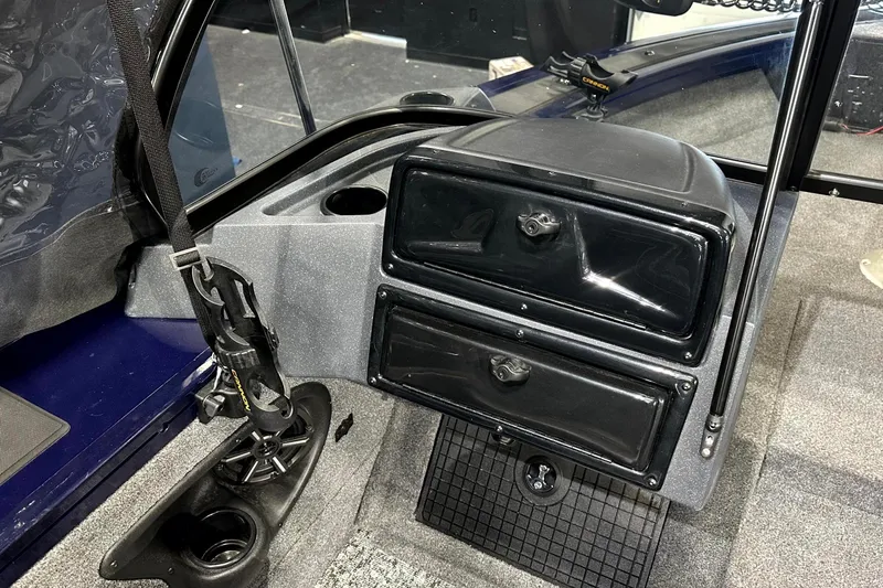 Slide: The Image of 2025 Tracker Targa V-19 WT boat interior with storage compartments and cup holder. - 16