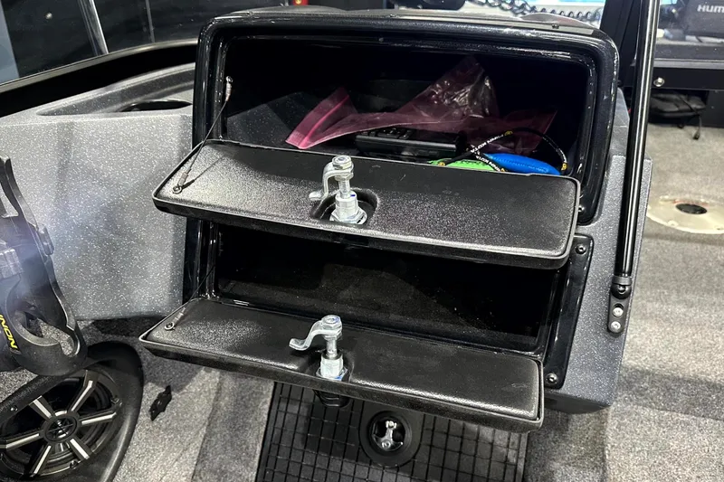 Slide: The Image of Storage compartment in 2025 Tracker Targa V-19 WT boat, featuring secure latches and organized interior. - 17