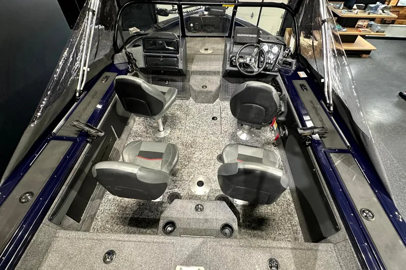 Slide: The Image of 2025 Tracker Targa V-19 WT boat interior with four seats and steering console. - 19
