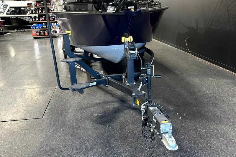 Slide: The Image of 2025 Tracker Targa V-19 WT boat on trailer in showroom setting. - 5
