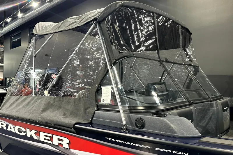 Slide: The Image of 2025 Tracker Targa V-19 WT boat with protective canopy in showroom display. - 7