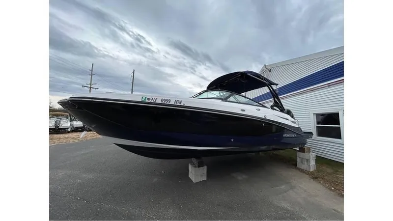 The Image of 2018 Monterey M65 boat on blocks, parked outdoors near a building. - 0