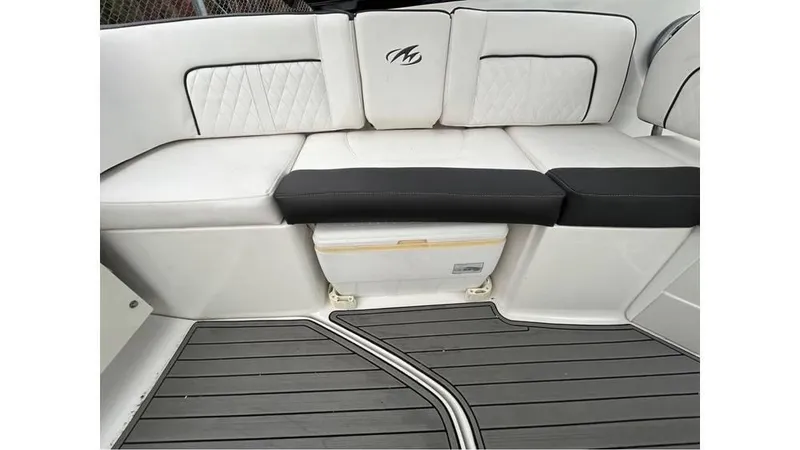 Slide: The Image of Monterey M65 2018 boat interior with white cushioned seating and gray flooring. - 10