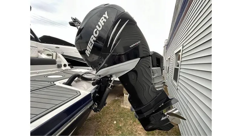 Slide: The Image of 2018 Monterey M65 boat with Mercury Verado outboard motor, docked beside a building. - 23