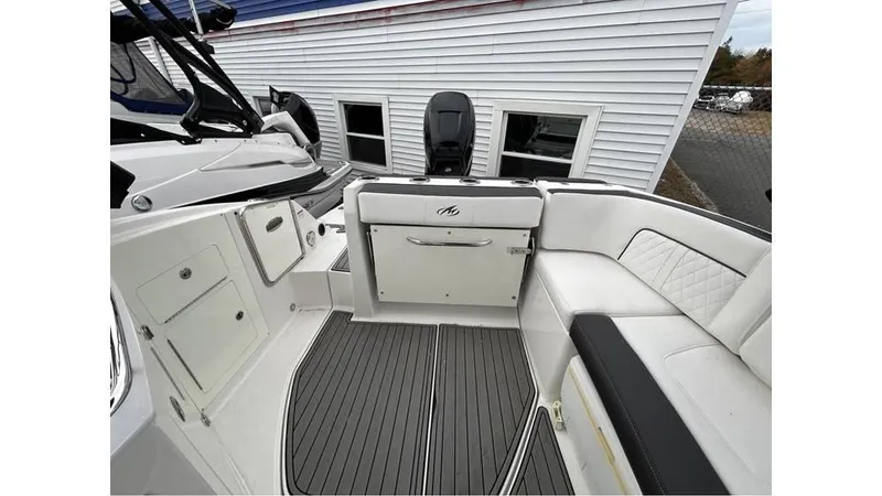 Slide: The Image of 2018 Monterey M65 boat interior with white seating and gray flooring. - 7