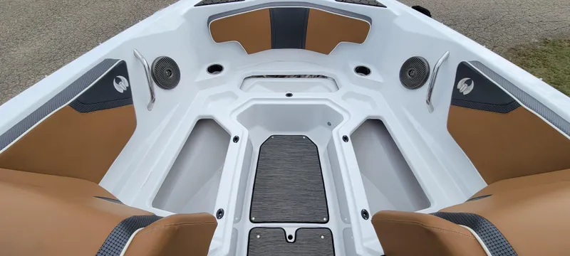 Slide: The Image of Interior view of 2021 Scarab 215 ID boat, featuring tan and gray seating. - 13