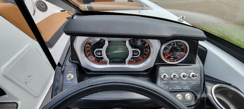Slide: The Image of Dashboard of a 2021 Scarab 215 ID boat with modern gauges and controls. - 16