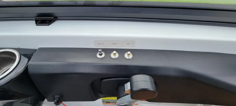 Slide: The Image of Control panel of 2021 Scarab 215 ID boat with switches and throttle lever. - 19