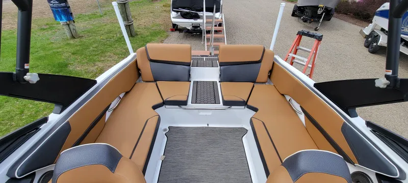 Slide: The Image of 2021 Scarab 215 ID boat interior with tan seating and modern design. - 20
