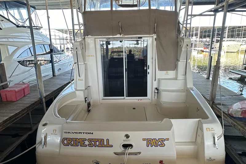 The Image of 2002 Silverton 35 Convertible yacht docked in marina, rear view. - 0