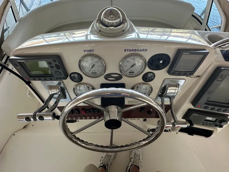 Slide: The Image of 2002 Silverton 35 Convertible helm with gauges, steering wheel, and navigation equipment. - 11