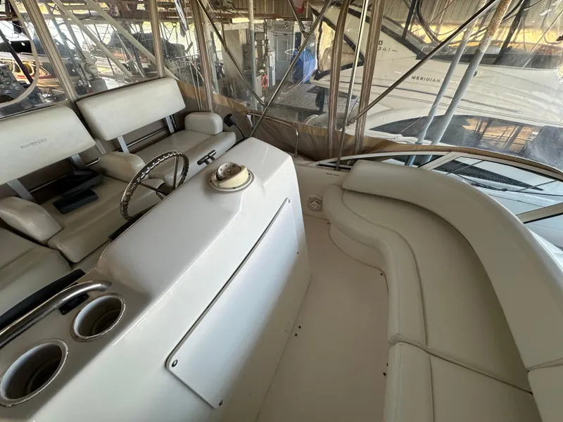 Slide: The Image of 2002 Silverton 35 Convertible yacht interior with helm and seating area. - 14