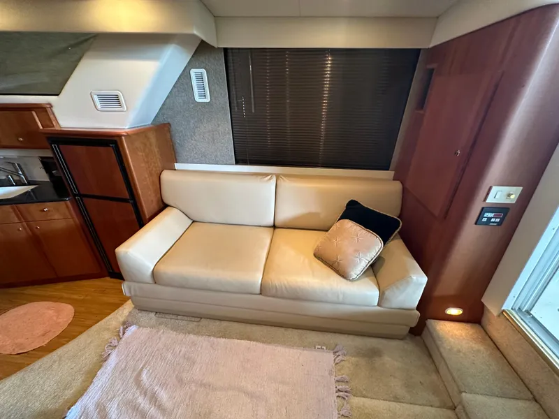Slide: The Image of Interior of 2002 Silverton 35 Convertible yacht with beige sofa and kitchen area. - 18