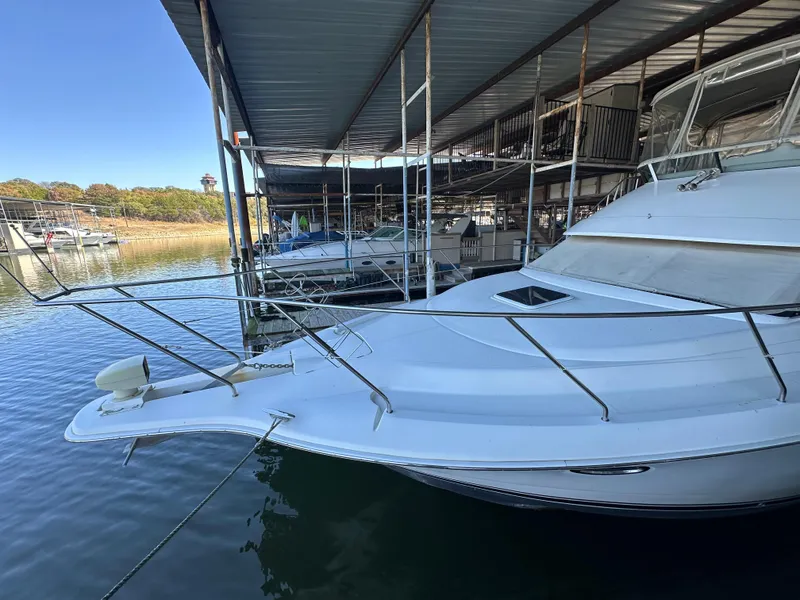Slide: The Image of 2002 Silverton 35 Convertible yacht docked in a marina. - 2
