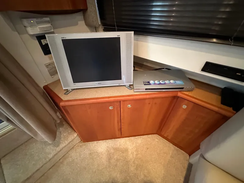 Slide: The Image of 2002 Silverton 35 Convertible interior with TV and DVD player on wooden cabinet. - 20