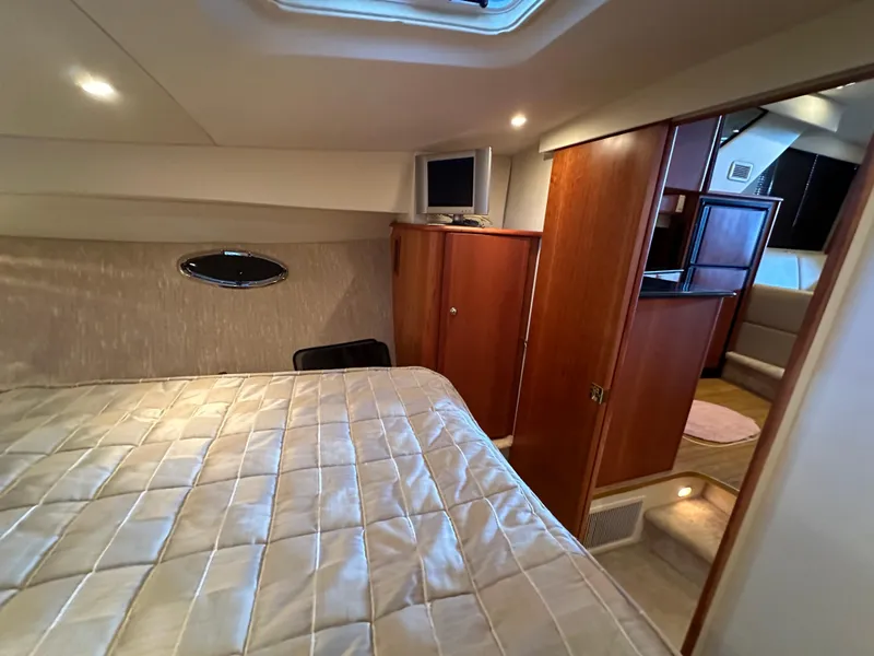 Slide: The Image of Interior of 2002 Silverton 35 Convertible yacht bedroom with bed and TV. - 27