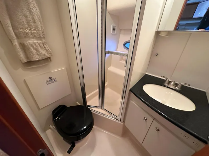 Slide: The Image of 2002 Silverton 35 Convertible yacht bathroom with shower, sink, and toilet. - 29