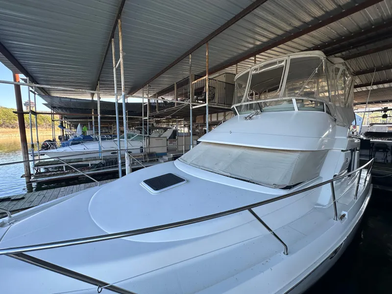 Slide: The Image of 2002 Silverton 35 Convertible yacht docked under covered marina. - 3