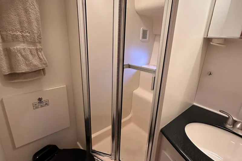 Slide: The Image of 2002 Silverton 35 Convertible yacht bathroom with shower and sink. - 31